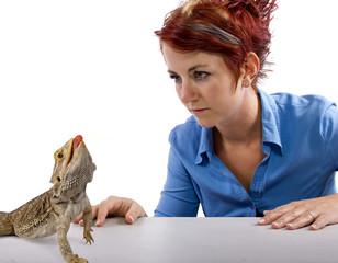 Spikey-haired girl staring at spikey bearded dragon reptile