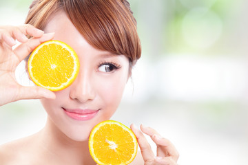 Beautiful woman face with juicy orange