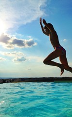 girl jumping in pool