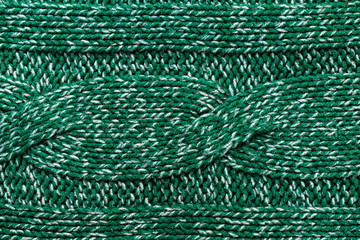 knitted jersey green background with a relief pattern. High reso