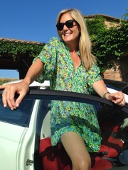 woman leaning on her car