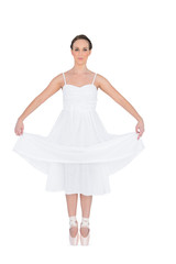 Naklejka premium Peaceful young ballet dancer standing on her tiptoes