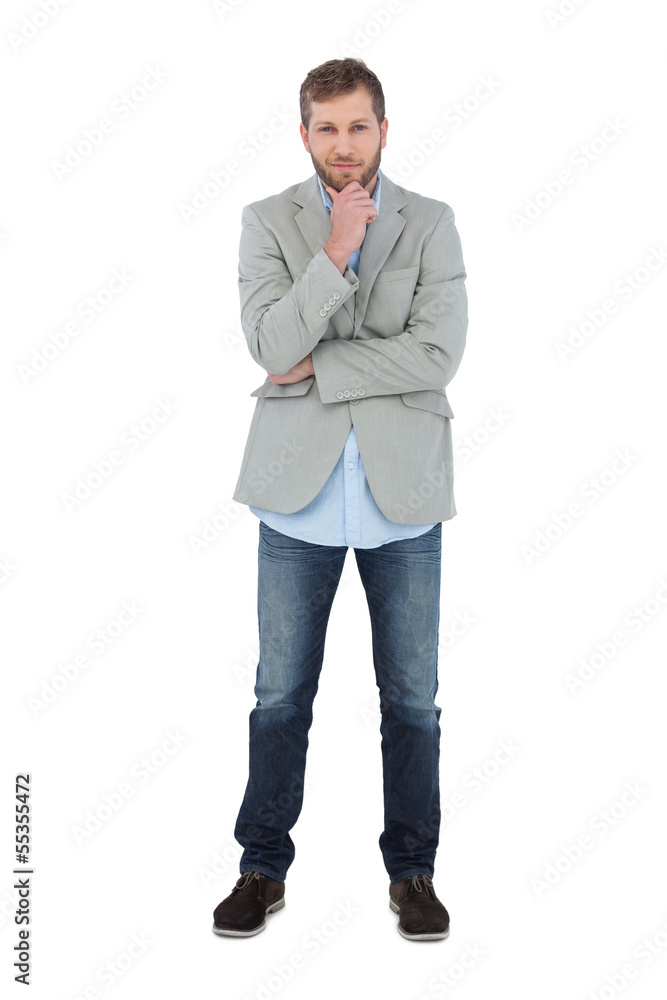 Poster thoughtful model posing in blazer looking at camera
