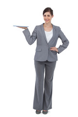 Smiling businesswoman holding tablet computer