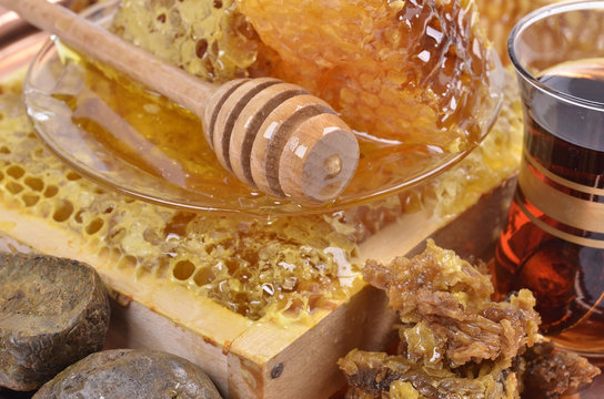 fresh  honeycombs  and wooden stick ,cup of Turkish tea