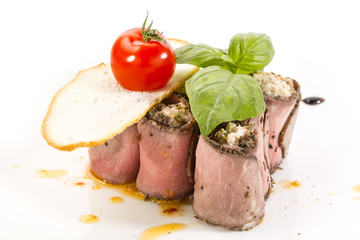 meat rolls with cheese decorated with tomato
