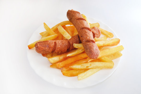 Fried sausage with french fries on gray background