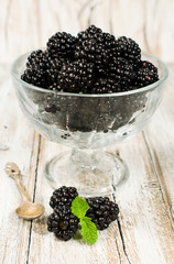 ripe blackberries in a glass vase