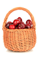 Cherry berries in wicker basket isolated on white