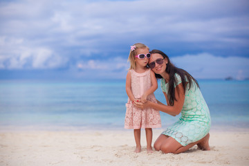 Young beautiful mother and her adorable little daughter enjoy