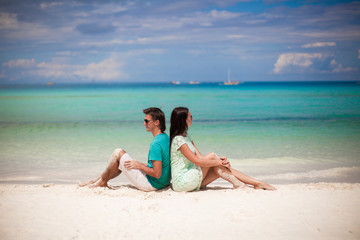 Fototapeta na wymiar Young couple enjoying each other on sandy beach