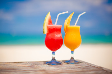 Two cocktails: fresh watermelon and mango on the background of