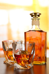 Glass of whiskey with bottle, on dark background
