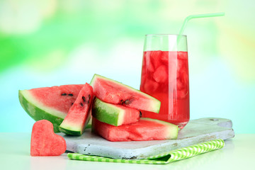 Fresh watermelon and glass of watermelon juice, outdoors