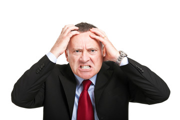 Angry businessman with hands in his head isolated on white