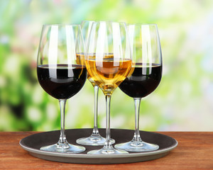 Glasses of wine, on bright background