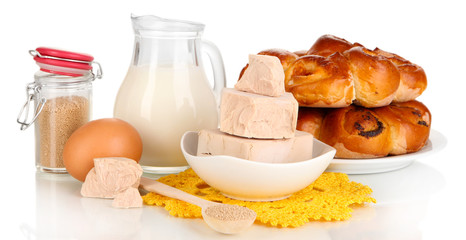 Dry yeast with pastry and baking ingredients isolated on white