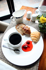 Hight view Coffee, bread and jam on a white plate.