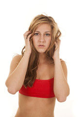 woman in red sports bra hands hair