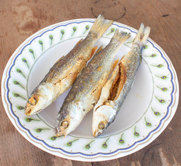 Three fried fish on the dish