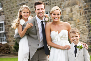 Bride And Groom With Bridesmaid And Page Boy At Wedding