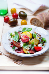 salad with red, yellow and black tomatoes and feta cheese
