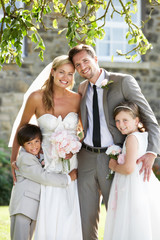 Bride And Groom With Bridesmaid And Page Boy At Wedding