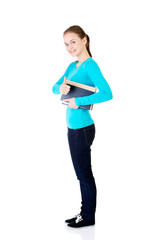 Fototapeta premium Attractive young student woman with book gesturing OK