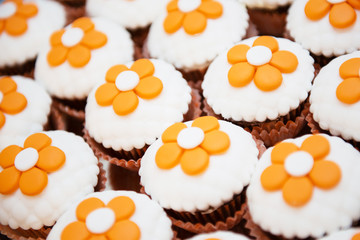 delicious chocolate cupcakes with orange flowers on top
