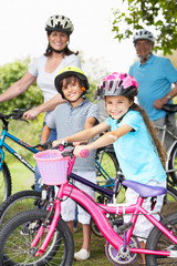 Grandparents And Grandchildren On Cycle Ride In Countryside