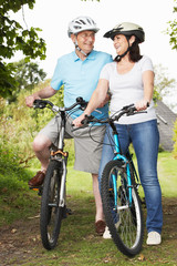 Senior Couple On Cycle Ride In Countryside