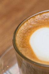 close up a cup of coffee on wooden table