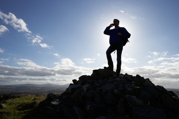 Silhouette Of Man Using Mobile Phone In Remote Countryside