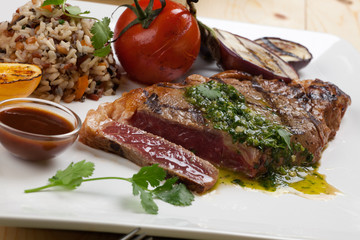 Piece of Medium Rare Steak with Spicy Herb Sauce