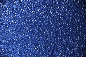 Abstract macro background with deep blue wet surface