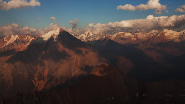 Picturesque time lapse of clouds moving fast over  mountains.