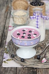 Yogurt with blueberry on wooden background
