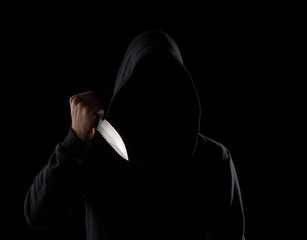 Dangerous hooded man holding knife