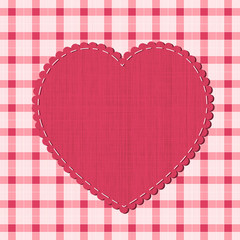 Checkered background with textile heart label