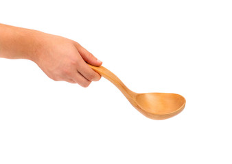 Hand holds wooden spoon.