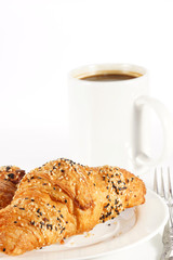 Delicious croissant with a cup of black coffee