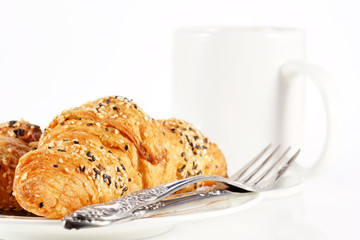 Delicious croissant with a cup of black coffee