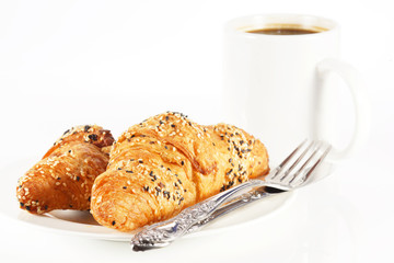 Delicious croissant with a cup of black coffee