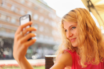 Young woman taking selfie on cell phone
