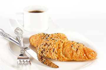 Delicious croissant with a cup of black coffee