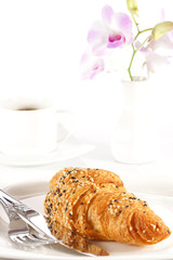 Delicious croissant with a cup of black coffee