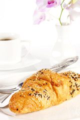 Delicious croissant with a cup of black coffee