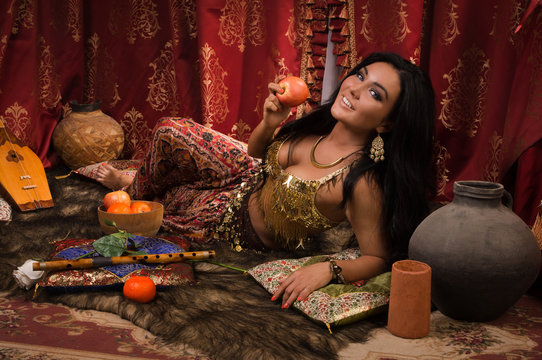 Beautiful woman in the arabic harem interior