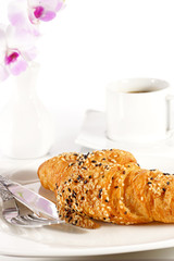 Delicious croissant with a cup of black coffee