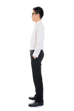 Young Asian business man full body side view isolated on white b